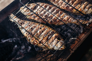 Grilled dorado fish with tomatoes, lemon and asparagus on a plate. Cooking recipe.