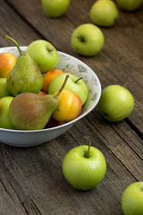 Appels and pears on a wooden background