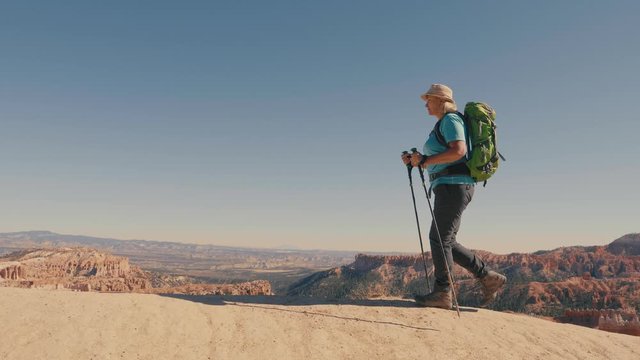 Tourist Hiking On Footpath Trail Of Orange Sandstone Rocks In Desert