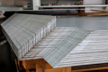 Sheet metal products are stacked on a pallet after a bending process.