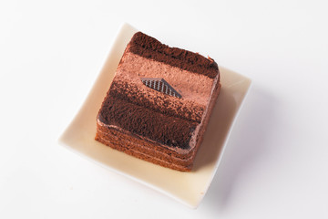 chocolate cake is layered in a plate on a white background.