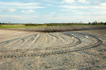 Traces of the tractor in the ploughed field