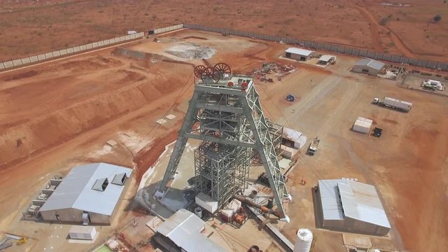 Aerial of mine shaft headgear construction at precious metal mine in Africa.