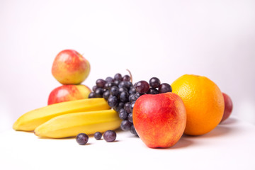  Still life of fruits on a white background, banana, apple, grapes