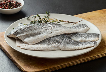 Raw sea bass fillet on a plate, seafood.