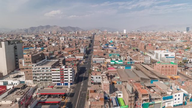 Panoramic skyline of Lima city from above with many buildings aerial timelapse. Poor houses with hills on a background. Traffic on streets. Lima, Peru