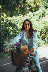 Attractive beautiful woman riding a bicycle in nature.