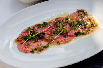Fresh raw meat with rocket.