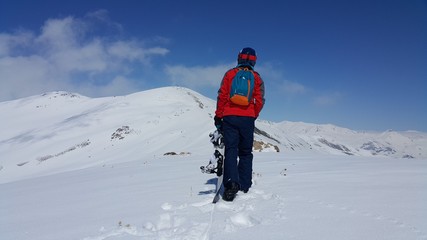 Fototapeta na wymiar a young skier skiing on the mountain, winter season and snow landscape 