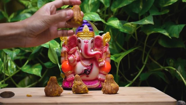 Close up of statue of lord Ganesha with modak during the Ganesh Chaturthi festival in India.