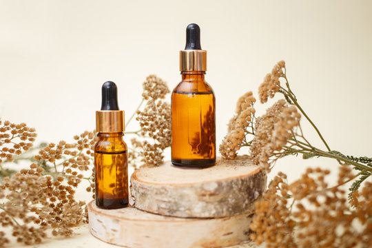 Dropper glass bottle skincare essential oil products for mock up in minimal style with on pastel cream background.