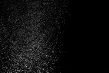 White dust on a black background, selective focus.