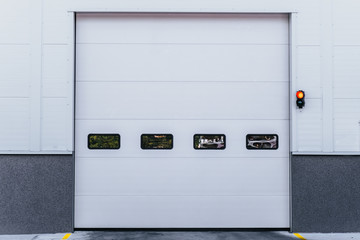White entrance gate door to the warehouse