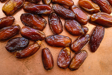 Dried dates on a copper surface. Monochrome image.