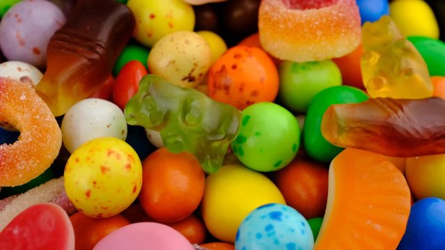 Candy sweets background. Assorted colorful mixed candies. Colorful delicious sweets turning macro.