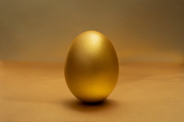 Gold egg on at golden the background