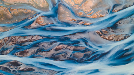 A glacial rivers from above. Aerial photograph of the river streams from Icelandic glaciers. Beautiful art of the Mother nature created in Iceland. Wallpaper background high quality photo - 373761588