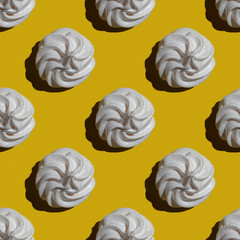 Seamless marshmallow or meringue pattern isolated on yellow background. Sweets and food themes