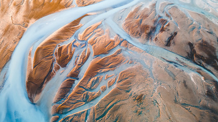 A glacial rivers from above. Aerial photograph of the river streams from Icelandic glaciers. Beautiful art of the Mother nature created in Iceland. Wallpaper background high quality photo - 373762556