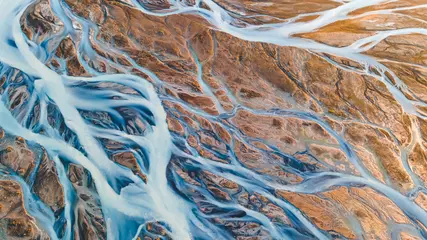Fototapete Lachsfarbe A glacial rivers from above. Aerial photograph of the river streams from Icelandic glaciers. Beautiful art of the Mother nature created in Iceland. Wallpaper background high quality photo