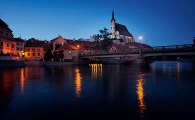 Naklejka premium Photography of Church of St. Vitus in Cesky Krumlov at night, and the Vltava river