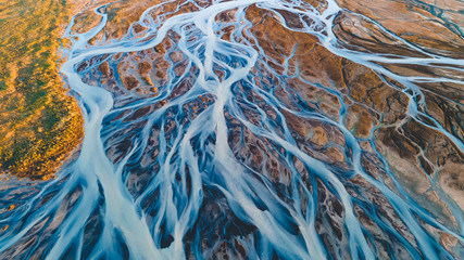 A glacial rivers from above. Aerial photograph of the river streams from Icelandic glaciers. Beautiful art of the Mother nature created in Iceland. Wallpaper background high quality photo - obrazy, fototapety, plakaty