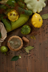 
Fresh vegetables, peppercorns and a small glass jar on a wooden background flat lay.