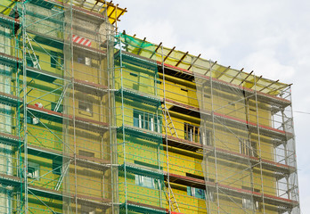 scaffolding arround the house to install thermal insulation of the apartment building facade