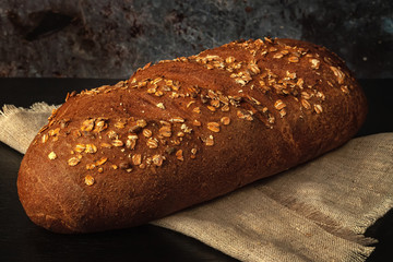 Fresh bread with bran, seeds and oatmeal on the table