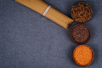 Pasta and legumes on gray background
