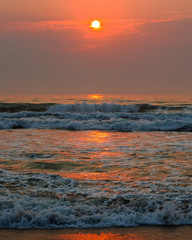 Fototapeta premium Beautiful pink sunset over the sea, vertical banner