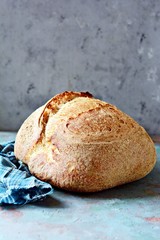 Homemade Freshly Baked Country Bread  made from wheat and whole grain flour on a gray background. French Freshly baked bread. 