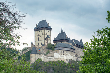 Fototapeta na wymiar Karlstejn gothic castle with trees frame, Czech Republic