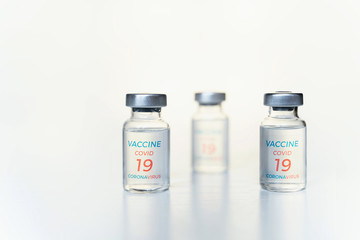 Closeup transparent vials with new vaccine for covid-19 coronavirus, flu, infectious diseases. Injection after clinical trials for vaccination of human, child, adult, senior. Medicine, drug concept