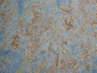 Texture of oxidized metal with brass and aqua patina. Rusty metal surface with streaks of rust. Rusty corrosion. Brown, grey, blue and orange rust and dirt on enamel. Corroded metal background.