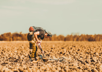 Man hunts for treasure with a metal detector