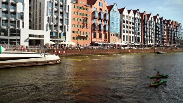 Gdansk, North Poland - August 15, 2020: People doing leisure activities such as kayaking in motlawa river over a weekend at city center main square