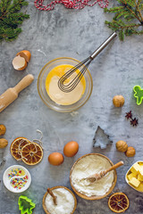 Christmas cookie recipe steps. Step four. Beaten egg with sugar and melted butter in a bowl. Ingredients for cooking flour, sugar, eggs, butter, spices, nuts, top view, flat lay