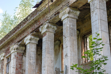 Fototapeta premium Detail of an old abandoned house. Moisture-damaged plaster. Old shabby cracked stucco.
