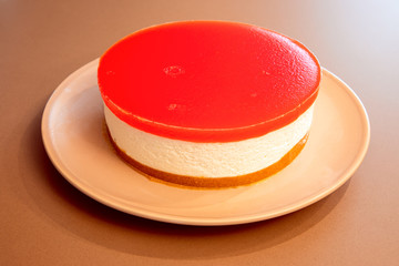 Homemade cheesecake with watermelon jelly on the top (close-up photo, selective focus)
