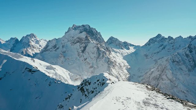 Snow capped mountains on a blue sky in Sunny weather, Caucasus mountains