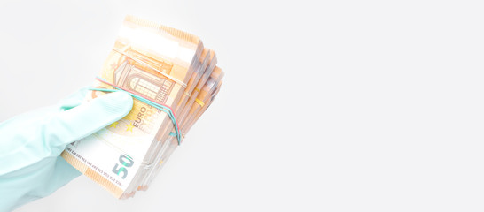 hand with gloves receiving, giving or holding euro cash banknote