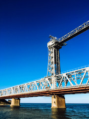 Fototapeta na wymiar Iron bridge over the blue sea.