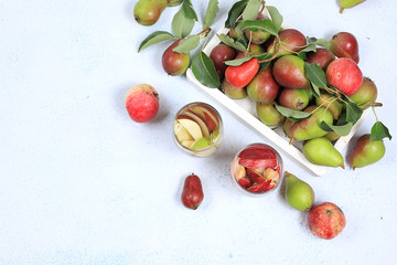 Apple and pear cider, juice or fruit drink and ingredients on a sunny table. The concept of diet and weight loss. Apples help cleanse the body and reduce weight. Healthy eating, body detoxification