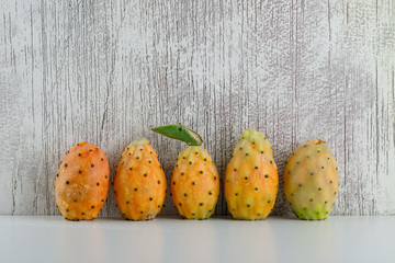 Prickly pears side view on white and grungy grey background