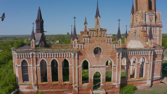 Church of St. Mary in the neo-gothic style in the village of Kamenka, Saratov region, Russia. The ruins of the church wall. Aero 4K