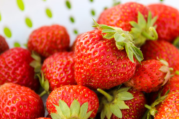 Background from freshly harvested strawberries, directly above. Summer photo with beautiful and juicy strawberries. Fresh organic berries macro. Red ripe. Close up, isolated. 
