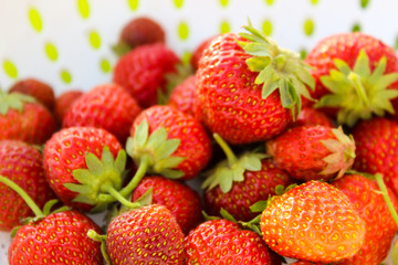 Background from freshly harvested strawberries, directly above. Summer photo with beautiful and juicy strawberries. Fresh organic berries macro. Red ripe. Close up, isolated. 