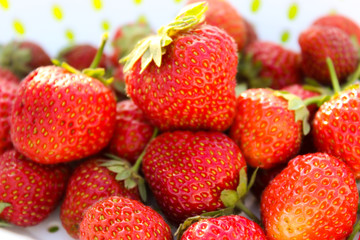Background from freshly harvested strawberries, directly above. Summer photo with beautiful and juicy strawberries. Fresh organic berries macro. Red ripe. Close up, isolated. 