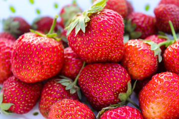 Background from freshly harvested strawberries, directly above. Summer photo with beautiful and juicy strawberries. Fresh organic berries macro. Red ripe. Close up, isolated. 